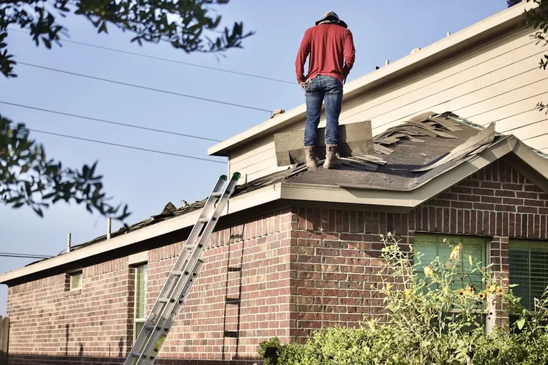 Professional roofer working on a residential roof in Madden Corners